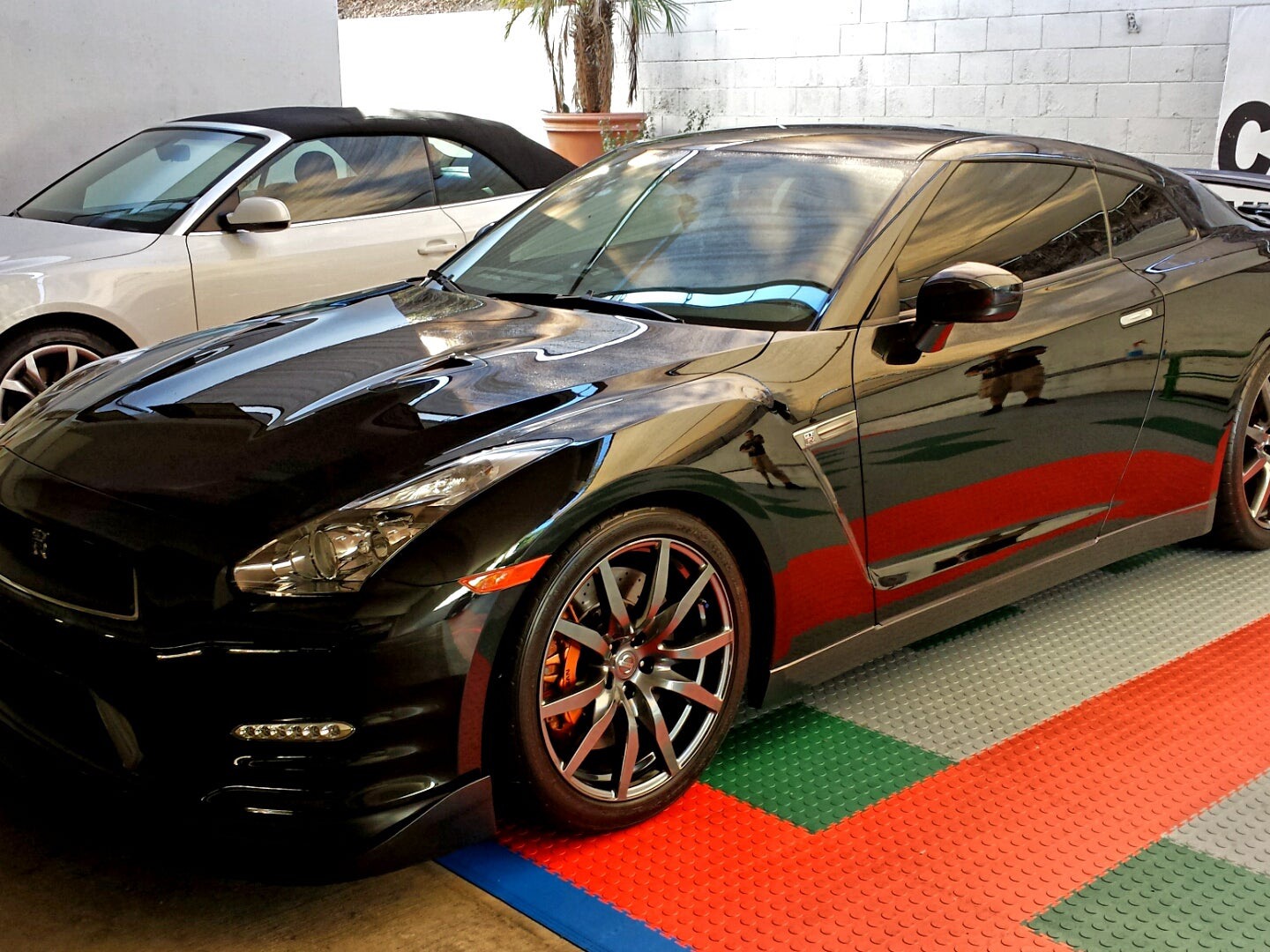Black Nissan GT-R gleaming after a Green Go wash