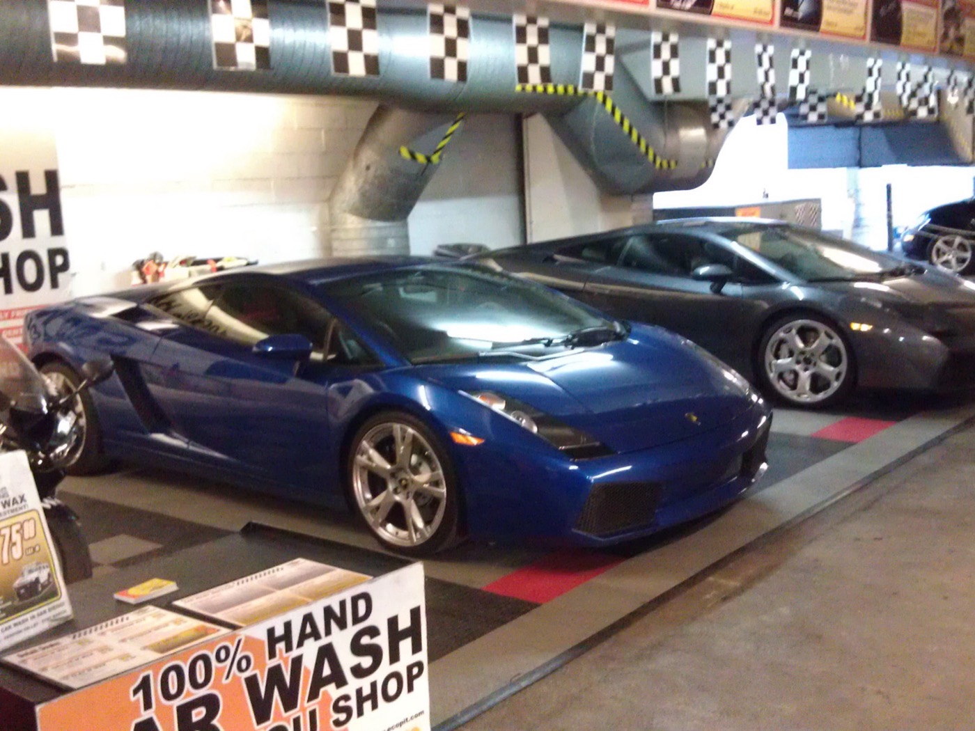 Two Lamborghini Gallardos parked in the Green Go Wash bay